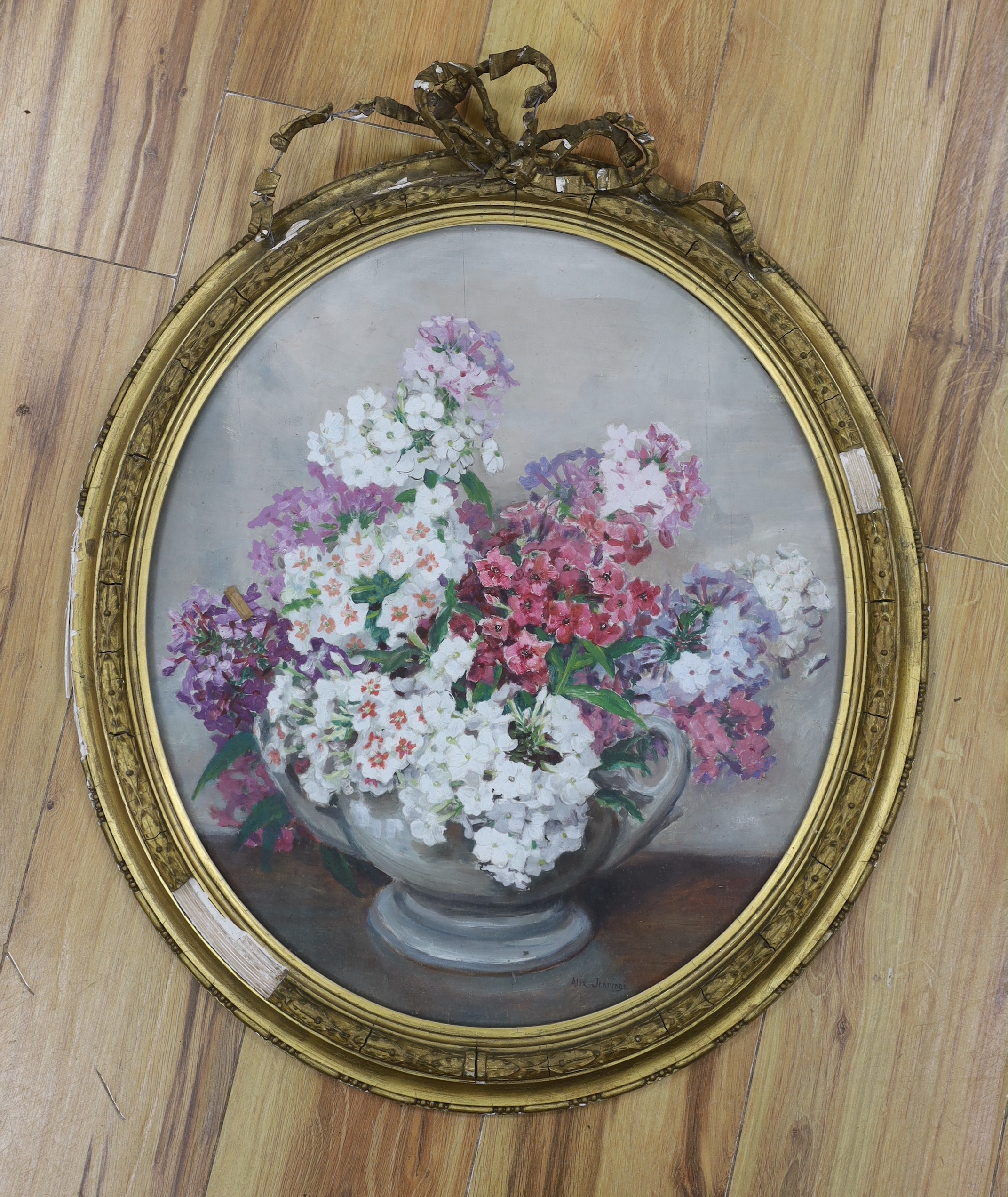 Alix Jennings (1884-1980), oil on board, Still life of flowers in a vase, oval, 50 x 44cm